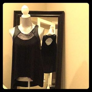 BCBG Black top with mesh and leather accents.